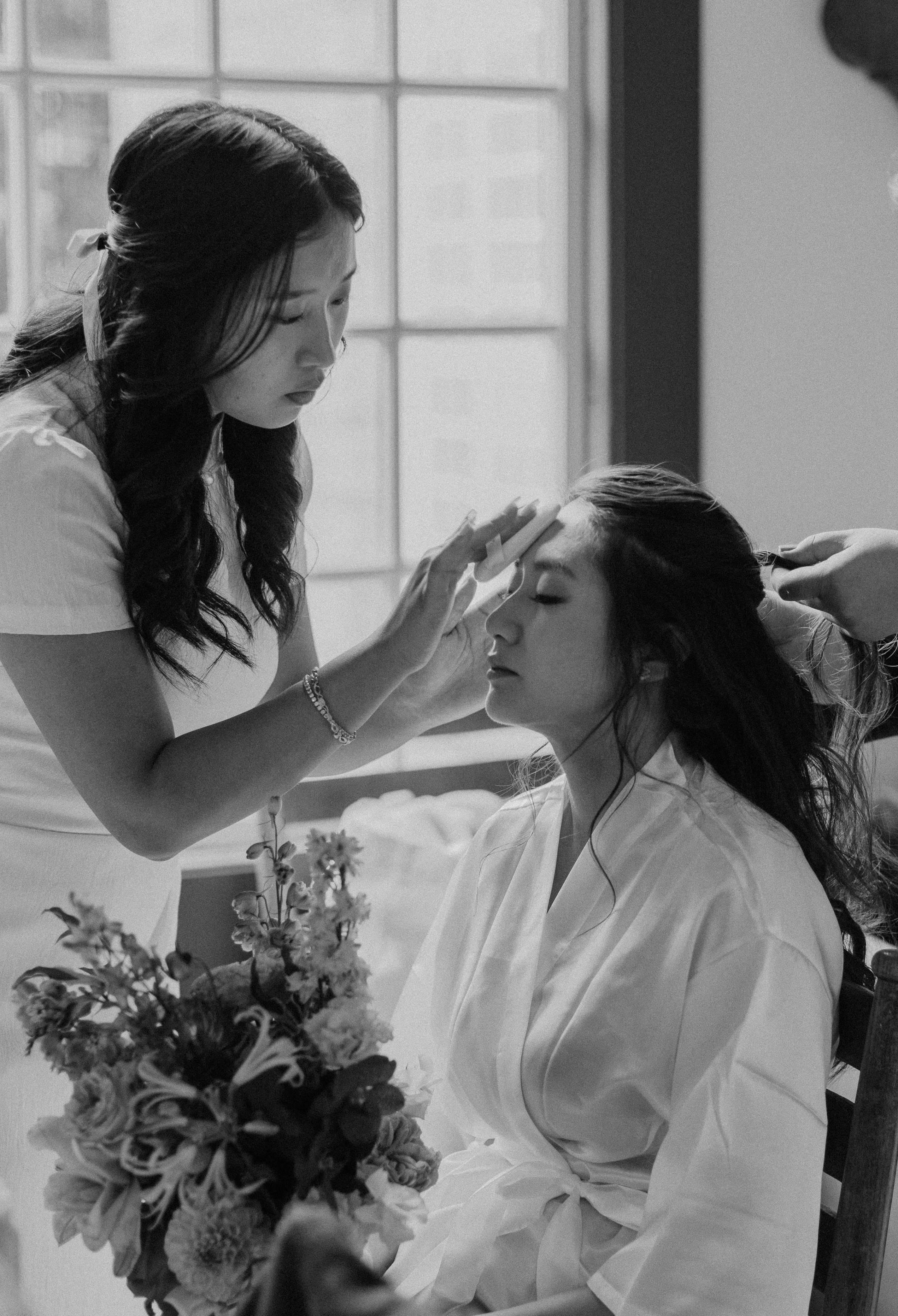 Carey applying makeup to a bride